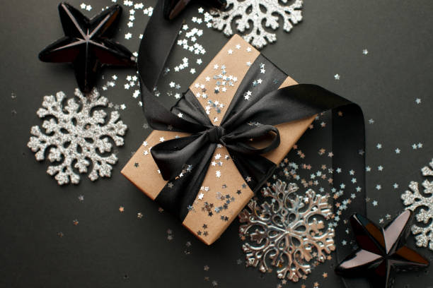 istock Christmas silver decor and handmade gift box on black background top view. Merry Christmas greeting card, frame. Winter xmas holiday theme. Happy New Year. 1185564976