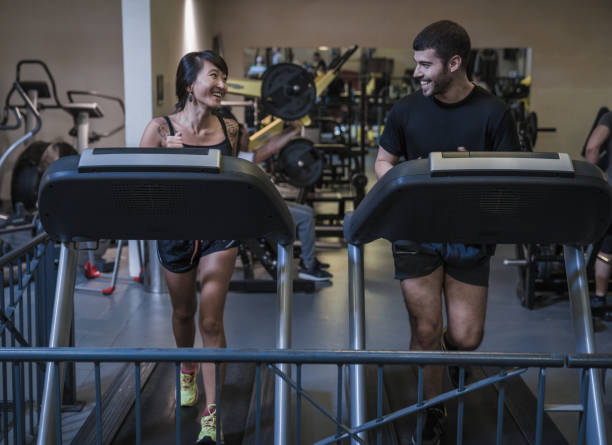 istock Attractive young couple doing workout on treadmill 1185566106