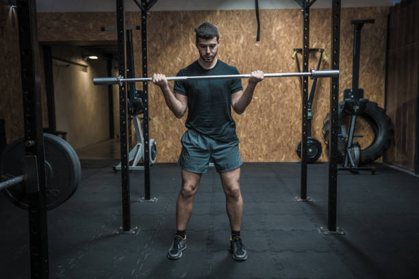 istock Attractive Fit man lifting heavy barbell 1185566245