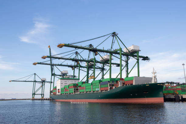 istock Logistics and transportation of Container Cargo ship and Cargo plane with working crane bridge in shipyard at sunny day, logistic import export and transport industry background - Image 1185566327