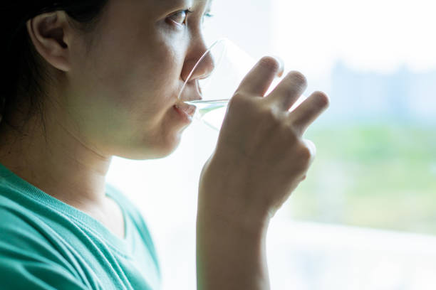 istock Asian woman drinking water. 1185567153