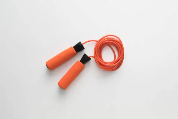 Skipping rope on white background flat lay
