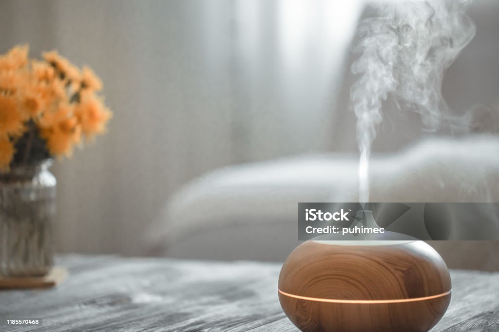 Humidifier on the table in the living room. Humidifier on the table in the living room. Ultrasonic technology, increase the humidity in the room, comfortable living conditions. Humidifier Stock Photo