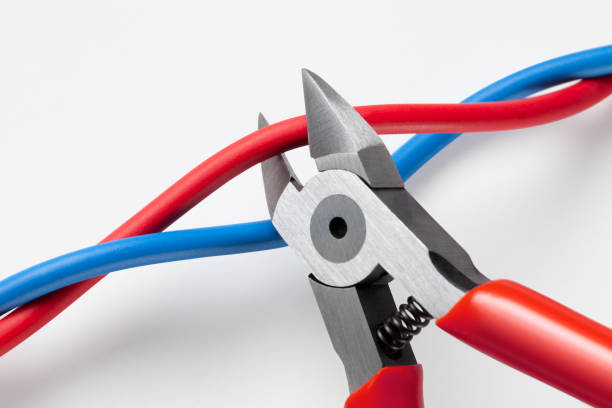 Cut the red wire or the blue wire? Photo with clipping path. Metal nippers is cutting red wire and leaving blue on white background. bolt cutter stock pictures, royalty-free photos & images