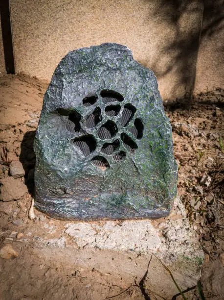 Photo of a stone-shaped speaker in the park