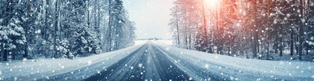 istock winter road, covered with snow on sunny day 1185572548
