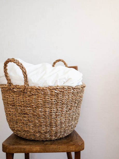 istock Large wicker basket with a white blanket on wooden rustic chair Copy space 1185576002