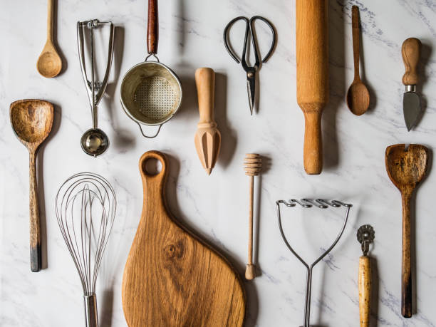 istock flat lay various metal and wooden kitchen tools on marble background. 1185576123