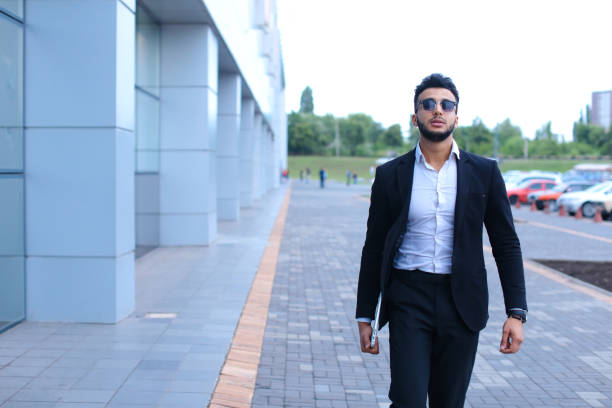 istock Arabic guy in business center stands smiling walking slow 1185579369