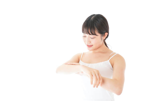 istock Young woman using a body milk 1185582904