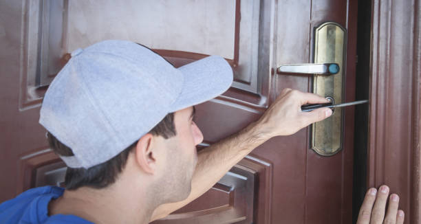 istock Master repairing the door lock with screwdriver. 1185583828