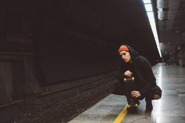 istock Young skateboarder waiting for the train 1185585557