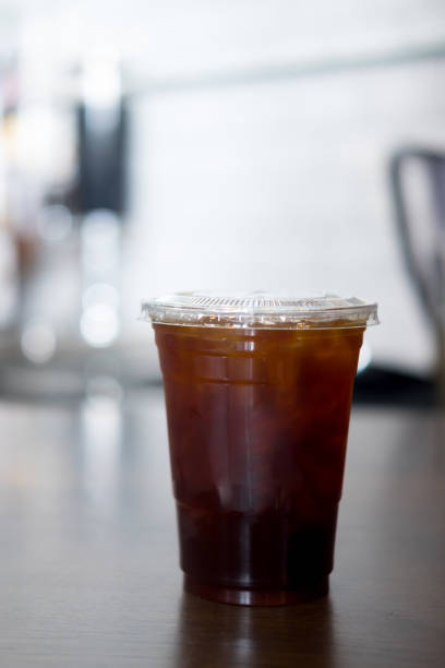 istock Ice black coffee on wood table. Cold summer drink 1185591221