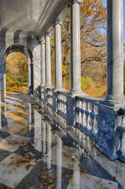 Columns of the Siberian Marble bridge inside with reflections during the Indian summer (Tsarskoye Selo, Saint Petersburg, Russia) vertical orientation