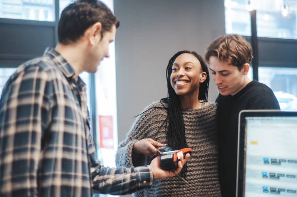 istock Diverse couple contactless paying in the bar 1185592236