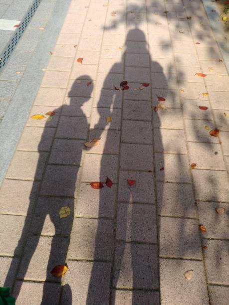 istock Shadows of mom and child 1185594048