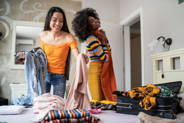 istock Girls packing clothes in suitcase for travel 1185596821