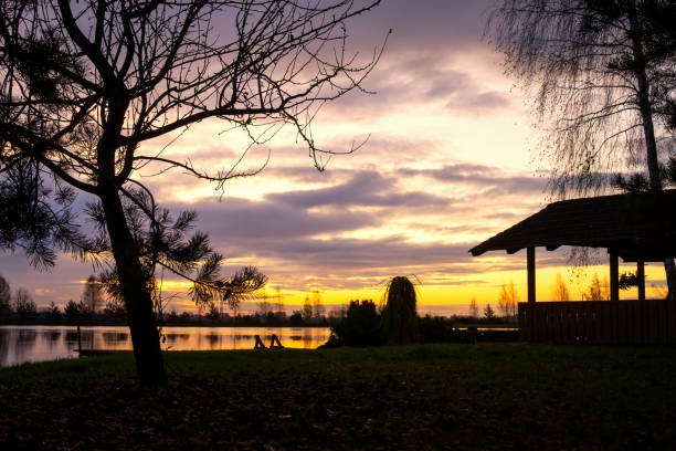 istock Tranquil lake reflecting a vivid orange sunset 1185601043