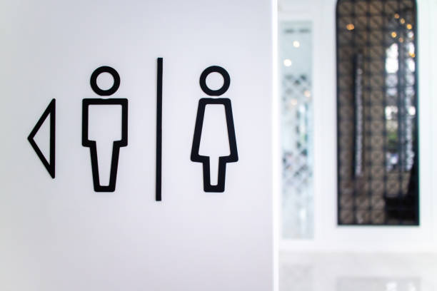 istock Restroom toilet sign on the wall shows direction on the left side 1185602954