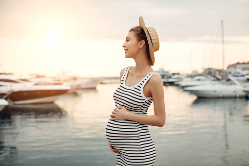 Pregnant girl walking around yacht club
