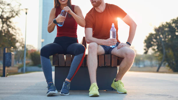 istock Modern couple making pause in an urban park during jogging / exercise. 1185604853