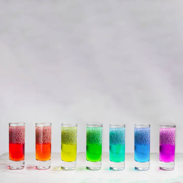 istock Seven Rainbow Shots with basil seeds brights drinks, on the grey textured background. Square with copy space for text and design. Minimal cpncept about healthy beverage. 1185605137