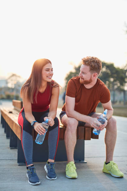 istock Modern couple making pause in an urban park during jogging / exercise. 1185605883