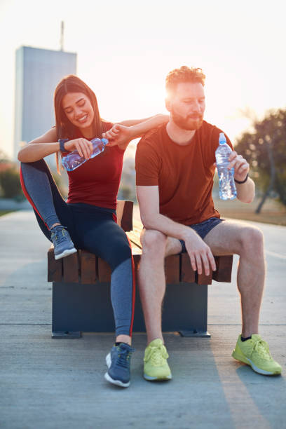 istock Modern couple making pause in an urban park during jogging / exercise. 1185607025