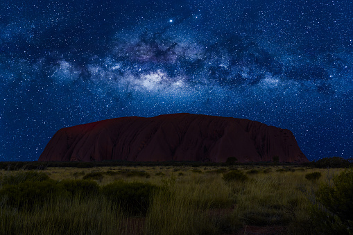 Uluru, Northern Territory, Australia - Aug 22, 2019: spectacular Uluru by night with milky way, stars field and galaxies. Uluru-Kata Tjuta National Park in Northern Territory, Central Australia.