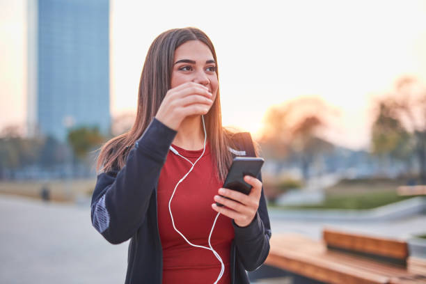 istock Modern young woman with cellphone making pause during jogging / exercise. 1185609220