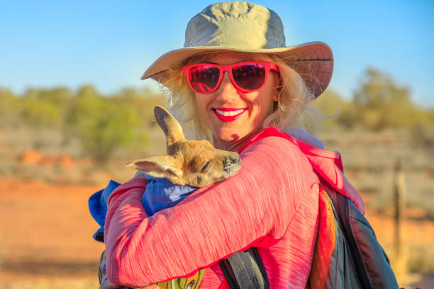 istock Woman holding kangaroo joey 1185609765
