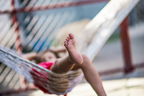 istock Little girl swinging on hammock 1185612358
