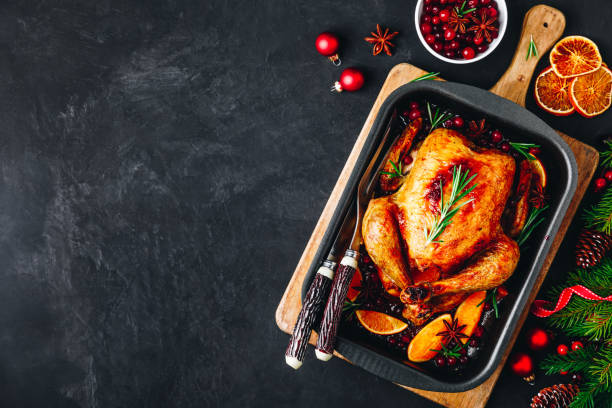 christmas baked chicken or turkey with spices, oranges and cranberries - christmas turkey imagens e fotografias de stock
