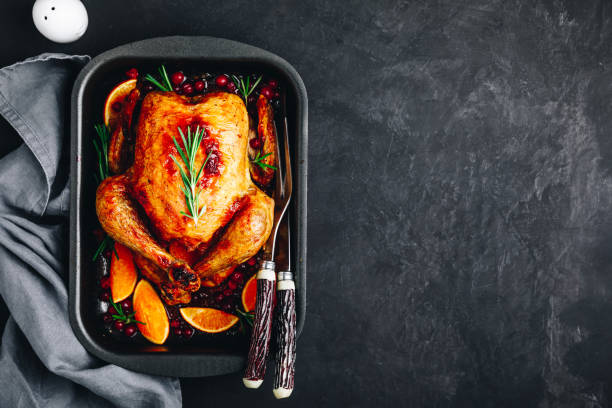 istock Thanksgiving baked chicken or turkey with spices, oranges and cranberries 1185612607