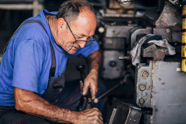 istock Manual worker working on a machine in factory alone 1185614030
