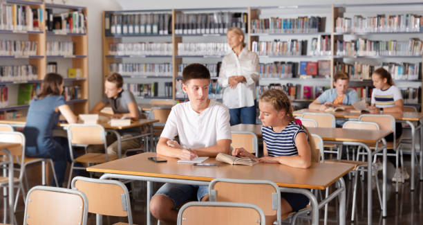 istock Schoolchildren preparing for lesson in school library 1185615595