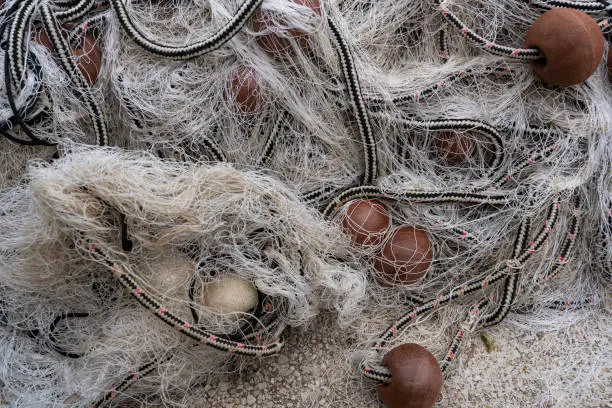 Detail of white, red and grey fishing net in Croatia.