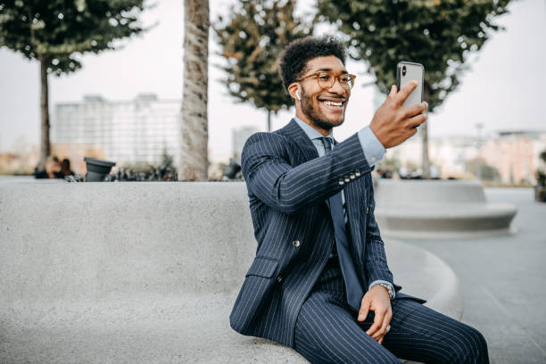 istock Handsome business man doing a video call outdoors 1185615926