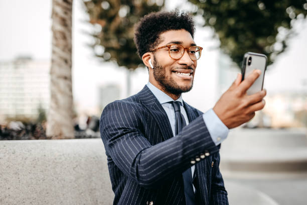 istock Handsome business man doing a video call outdoors 1185616687