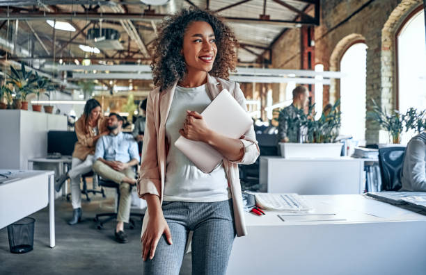 Young business people in office Group of young multiracial business people are working in modern office. Freelancers in coworking place. Creative and stylish youth. modern lifestyle stock pictures, royalty-free photos & images