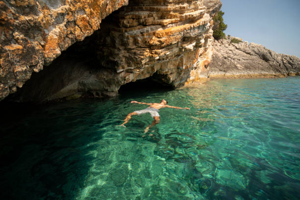 istock Man sunbathing and relaxing at the sea 1185621568