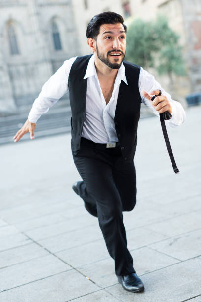 istock Hurrying man running along old street 1185622234