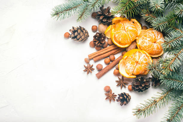 istock Tangerines without peel, Christmas tree branches, spices, cinnamon, cones on a white stone background. Concept of Christmas, New Year, Mulled Wine. Flat lay, top view. 1185622273