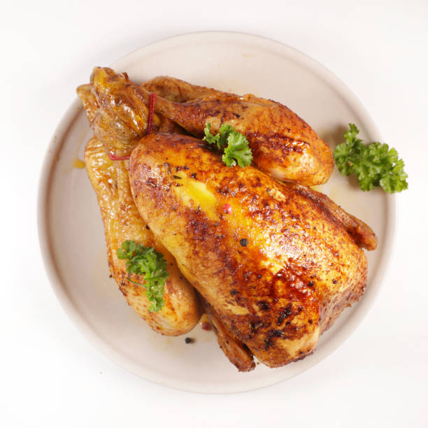 istock baked chicken and herb isolated on white background 1185622881