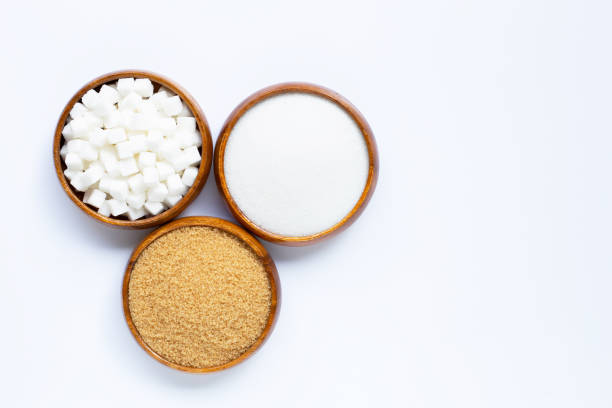 istock Wooden bowl with sugar on white background. 1185623042