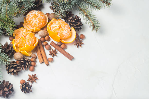 istock Tangerines without peel, Christmas tree branches, spices, cinnamon, cones on a white stone background. Concept of Christmas, New Year, Mulled Wine. Flat lay, top view. 1185623214