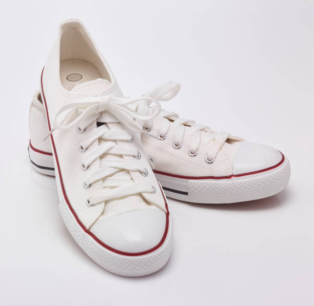 istock white sneakers shoes in the white background 1185623904