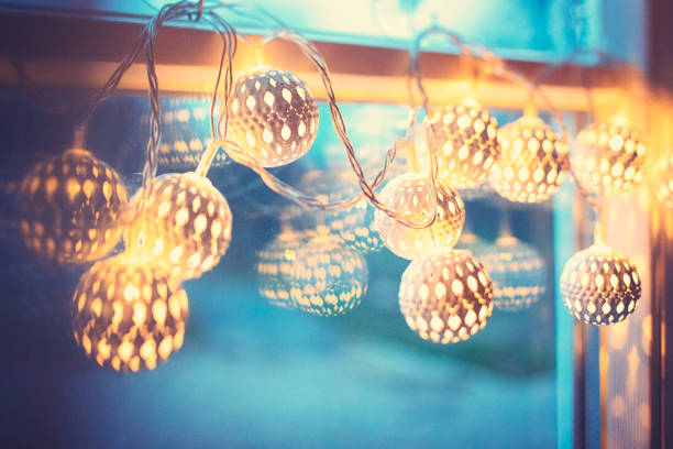 istock Golden pretty christmas lights on the window 1185624210