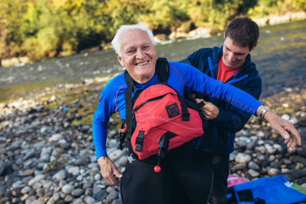 istock Senior man preparing for kayak tour on a mountain river. 1185626412