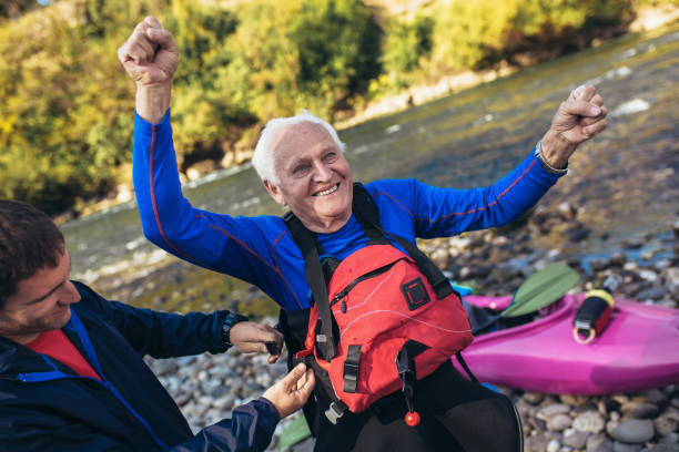 istock Senior man preparing for kayak tour on a mountain river. 1185626568